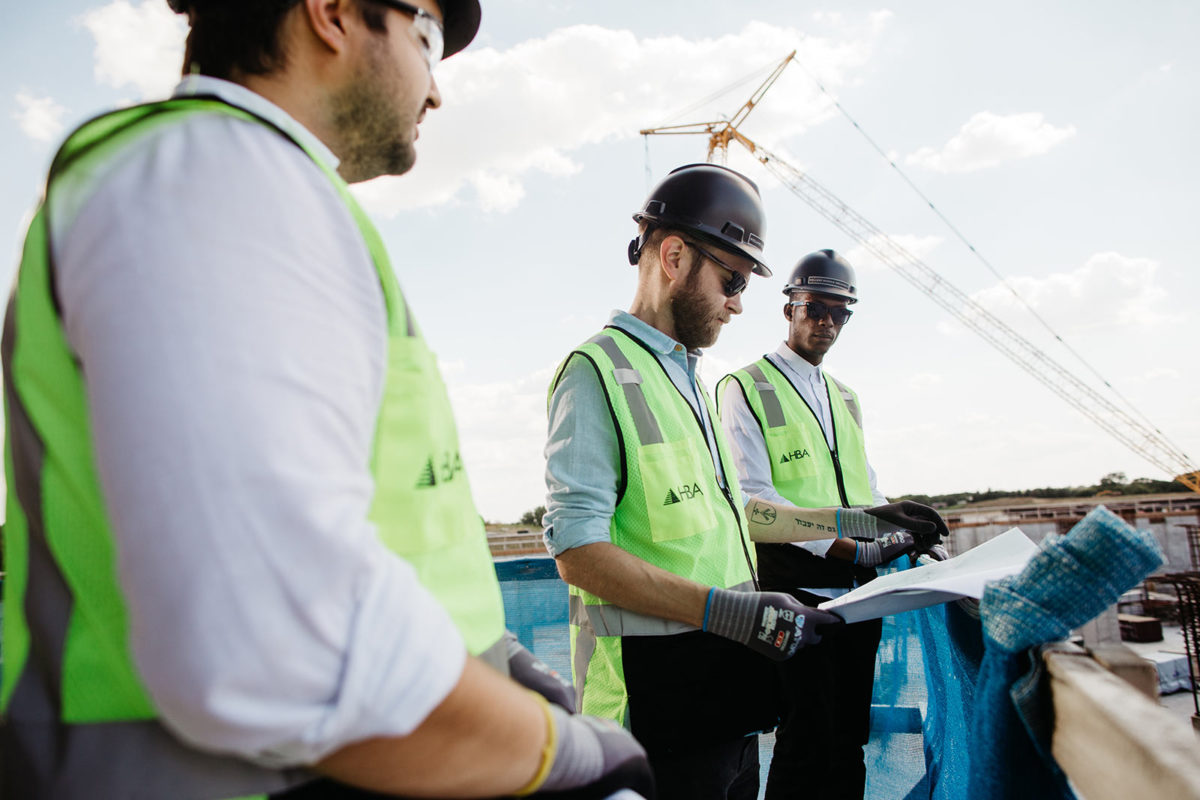 Coworkers Reviewing Plans on Job Site