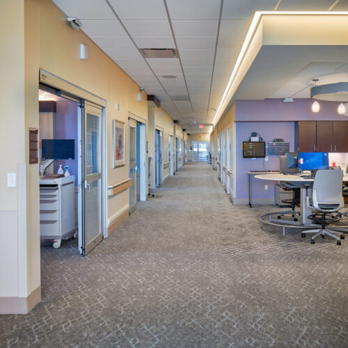 Hallway leading to NICU rooms with upgraded interior finishes and lighting.