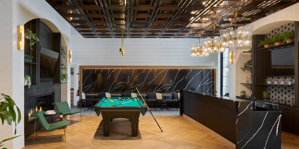 lounge room with bar, pool table, fireplace and various seating.